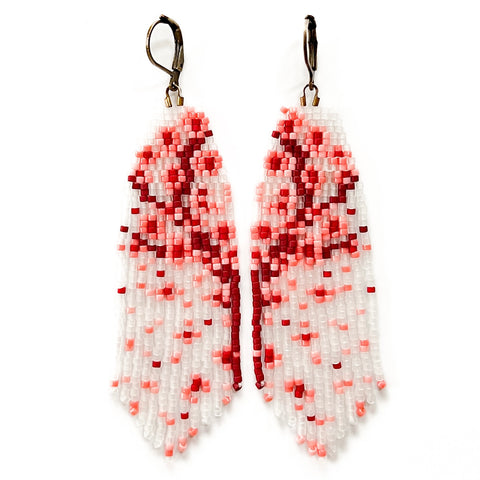 A pair of handmade earrings with translucent glass seed beads featuring a pink and red floral pattern.