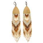 Long brown and gold beaded earrings with a raw brass charm.