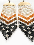 'ABIQUIU' unique handmade beaded long statement fringe earrings photographed at an angle on a white background.